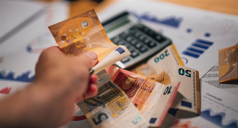 Ile zarabia kierowca CE w Niemczech w 2027 roku? Stawki, systemy i diety 1 Banknoty euro i kalkulator na dokumentach, wypłata kierowcy CE w Niemczech